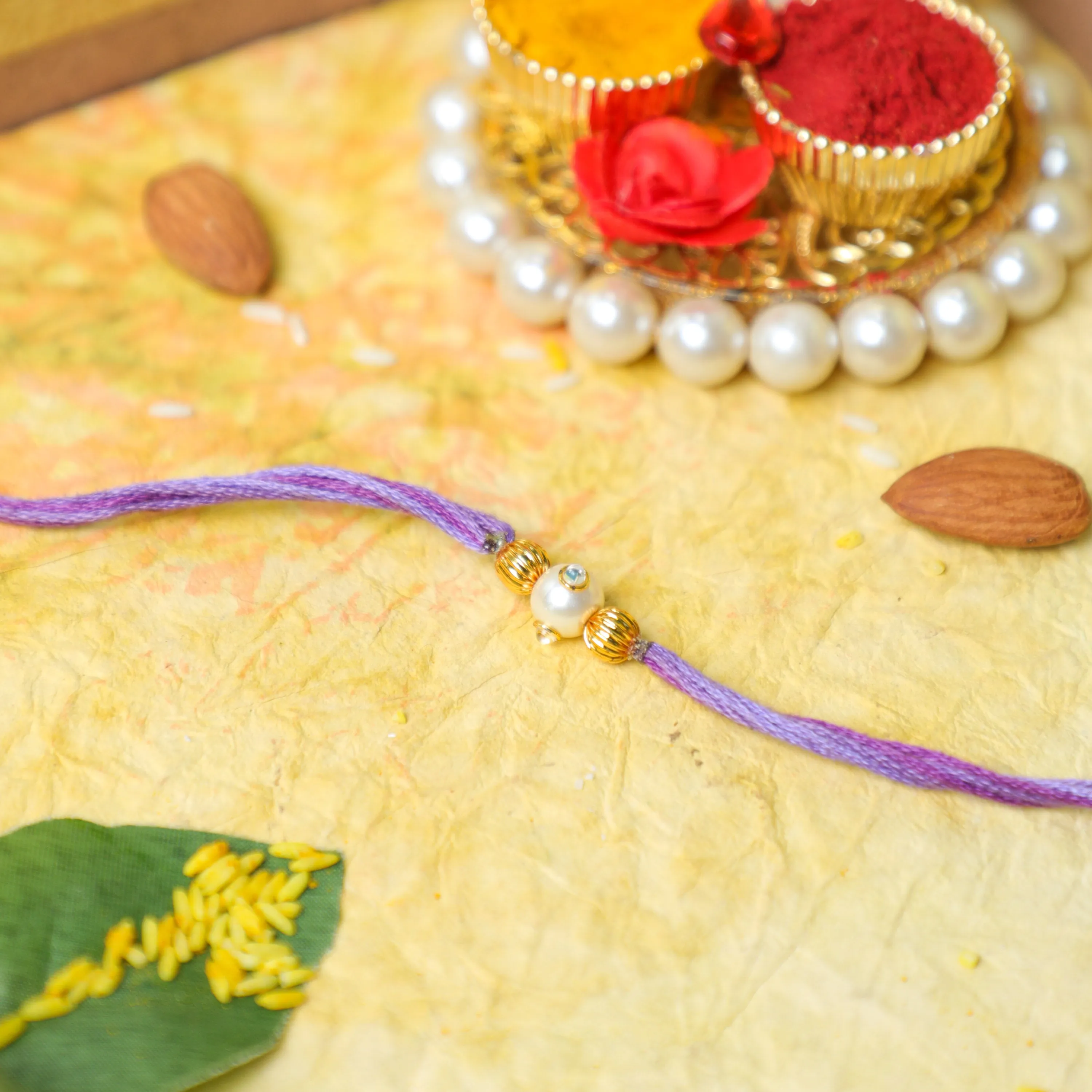 Handmade Pastel Purple Rakhi Thread With Pearl and Gold Beads